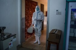 A technician carries samples from truck drivers testing for COVID-19 at the laboratory of Kenya Medical Research Institute (KEMRI) in Busia, a town bordering with Uganda in western Kenya, on May 14, 2020.