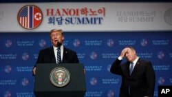 President Donald Trump speaks as Sec of State Mike Pompeo looks on during a news conference after a summit with North Korean leader Kim Jong Un, Thursday, Feb. 28, 2019, in Hanoi. (AP Photo/ Evan Vucci)