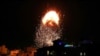 Smoke and flames rise above a building during Israeli airstrikes, amid a flare-up of Israeli-Palestinian fighting, in Gaza City, May 17, 2021. 