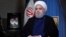 In this photo released by official website of the office of the Iranian Presidency, President Hassan Rouhani addresses the nation in a televised speech in Tehran, Aug. 6, 2018. 