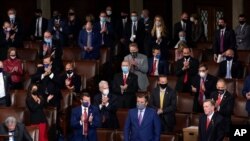 FILE - Republican lawmakers applaud after Arizona Congressman Paul Gosar, lower right, objected to certifying the Electoral College votes from his state, during a joint session of Congress, at the Capitol, in Washington, Jan 6, 2021. 