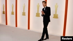 Austin Butler poses on the champagne-colored red carpet during the Oscars arrivals at the 95th Academy Awards in Hollywood, Los Angeles, California, March 12, 2023.