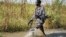 A rebel soldier patrols a flooded area near the town of Bentiu in Unity state. A report by the Geneva-based Small Arms Survey warns that both the rebels and government forces are planning new offensives in Unity state and elsewhere in South Sudan.