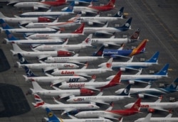 FILE - Dozens of grounded Boeing 737 Max aircraft are seen parked at Grant County International Airport in Moses Lake, Washington, Nov. 17, 2020.