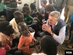 U.N. High Commissioner for Refugees Fillipo Grandi talks with new South Sudan refugee arrivals at the Imvempi reception center in Arua, Uganda, Jan. 30, 2018. (H. Athumani/VOA)