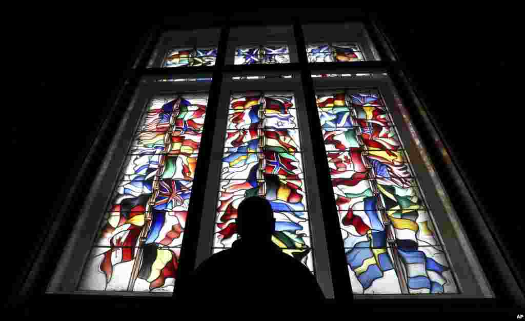 Mark Kirkpatrick, caretaker for Lockerbie Townhall, is seen looking at the glass window memorial to the victims of Pan Am flight 103 bombing, in Lockerbie, Scotland.