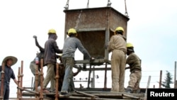 Laborers work at a railway station construction site in Ethiopia's capital, Addis Ababa, Sept.16, 2013.