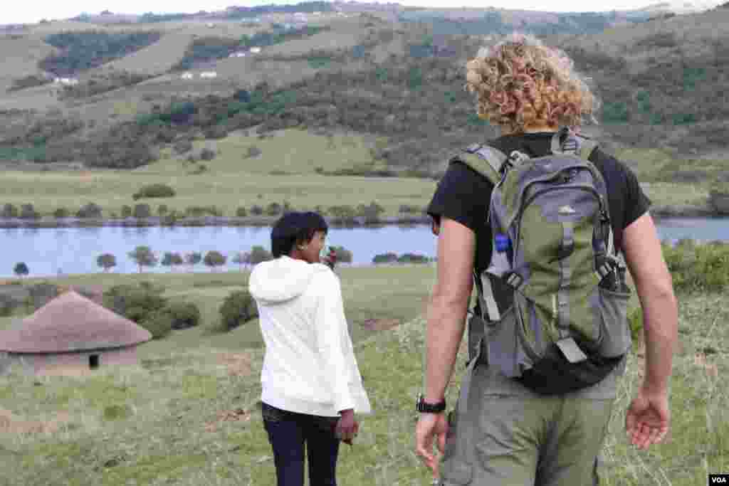 Buselwa Senyuko [front] and Sam Partington on their way to meet the ferry at the Xhora River (VOA/D. Taylor)
