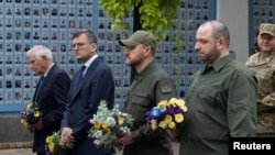 Ukraine's Defence Minister Rustem Umerov, Minister of Internal Affairs Ihor Klymenko, Foreign Minister Dmytro Kuleba and European Union Foreign Policy Chief Josep Borrell visit the Memory Wall of Fallen Defenders of Ukraine in Kyiv, Oct. 1, 2023. 