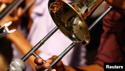 FILE - A musician plays a trombone during the first day of the New Orleans Jazz and Heritage Festival in New Orleans, Louisiana, April 25, 2014. 