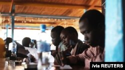 FILE - Displaced South Sudanese students take a math examination at a United Nations base in Juba, Jan. 17, 2014.