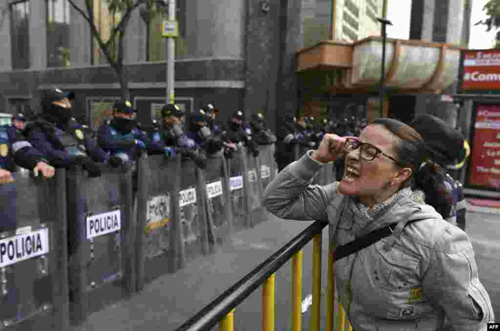 A demonstrator shouts slogans in front of the Senate building during a protest against the potential approval of an Internal Security Law which would allow the army to act as police, in Mexico City.