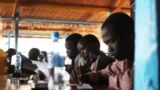 FILE - Displaced South Sudanese students take a math examination at a United Nations base in Juba, Jan. 17, 2014.