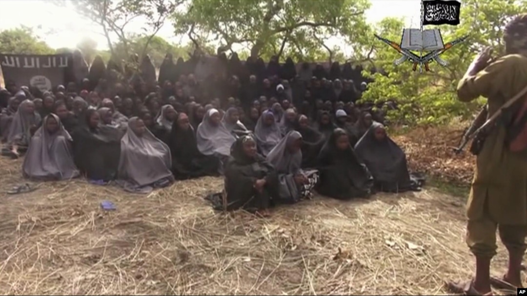 In this photo taken from video by Nigeria's Boko Haram terrorist network, Monday May 12, 2014 shows the alleged missing girls abducted from the northeastern town of Chibok. The new video purports to show dozens of abducted schoolgirls, covered in jihab 