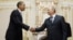 US President Barack Obama, left, shakes hands with Vladimir Putin at Novo Ogaryovo in Moscow, July 7, 2009 (file photo).