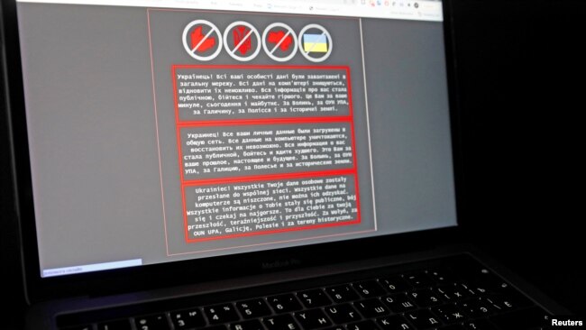 A laptop screen displays a warning message in Ukrainian, Russian and Polish, that appeared on the official website of the Ukrainian Foreign Ministry after a massive cyberattack, in this illustration taken Jan. 14, 2022.