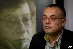 FILE - Palestinian novelist Atef Abu Saif attends a workshop in the West Bank city of Ramallah, March 1, 2015.