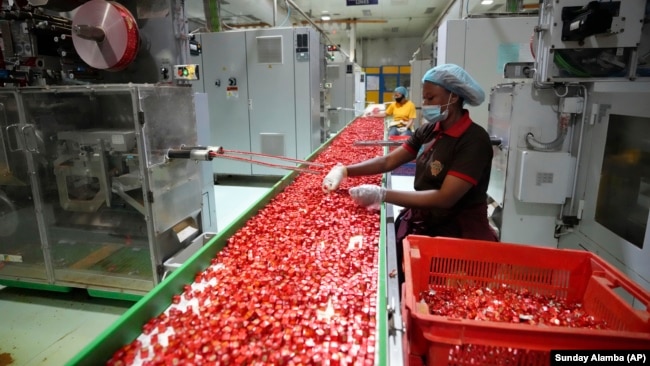 Workers package bouillon cubes at the Sweet Nutrition factory in Ota, Nigeria, Thursday, Sept. 12, 2024.