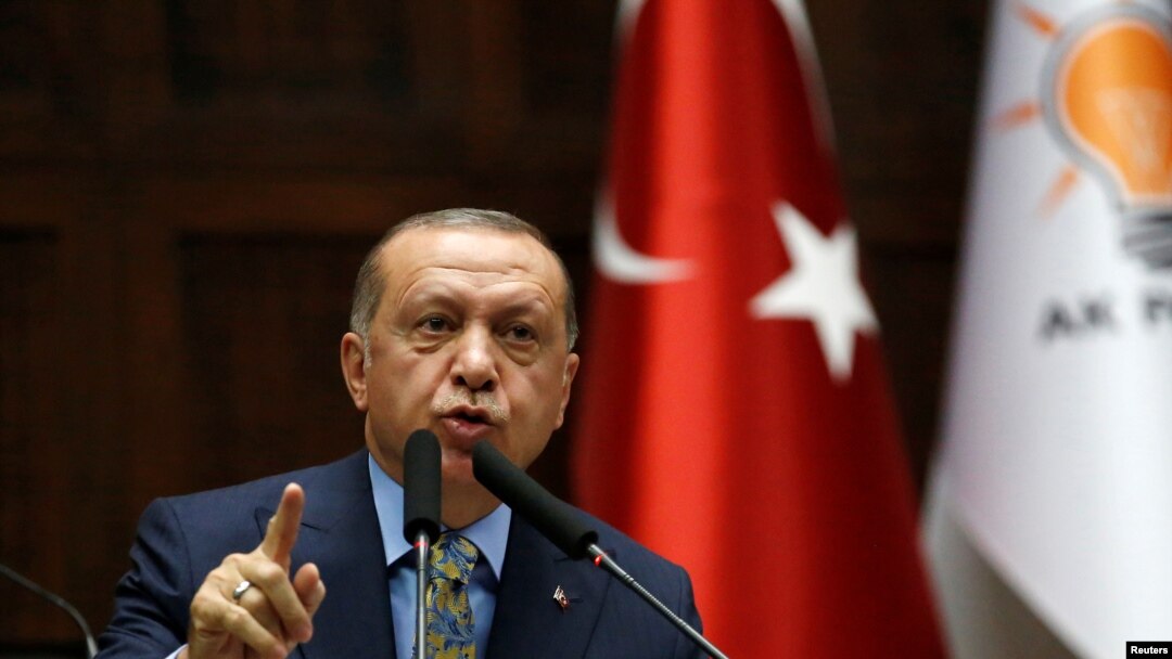 FILE - Turkish President Tayyip Erdogan addresses members of parliament from his ruling AK Party (AKP) during a meeting at the Turkish parliament in Ankara, Turkey, Oct. 23, 2018.