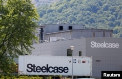 FILE - A trailer of office furniture maker Steelcase Inc. is seen in front of the company's plant in Wisches near Strasbourg, Eastern France, June 26, 2014.