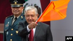 Mexican President Andres Manuel Lopez Obrador (R) and National Defense Secretary Luis Cresencio Sandoval officially mark the beginning of construction of a new international airport, at Santa Lucia Air Force Base in Zumpango near Mexico City, April 29, 2019.
