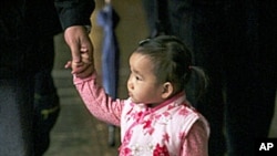 A young boy holds his sister as their family prays at a local temple. Taiwanese official has urged citizens to procreate amid fears the Year of the Tiger may bring reduced reproduction on the island already with one of the world's lowest birth rates, (Fil