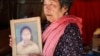 Peou Heng, 70, holds a picture of her daughter who passed away in the 1997 grenade attack in Phnom Penh, Cambodia, February 28, 2017. (Hean Socheata/VOA Khmer) 