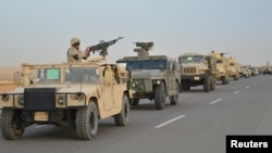 Egyptian Army armored vehicles are seen on a highway traveling toward north Sinai during a launch of a major assault against militants, in Ismailia, Egypt, in this undated handout picture made available by Egypt's Ministry of Defense Feb. 9, 2018.