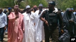 Borno State governor Kashim Shettima (left) visited the Chibok school where gunmen abducted more than 200 girls early last week.