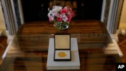 The 2021 Nobel Prize for Literature medal is seen at the Swedish Ambassador's Residence in London, Dec. 6, 2021. 