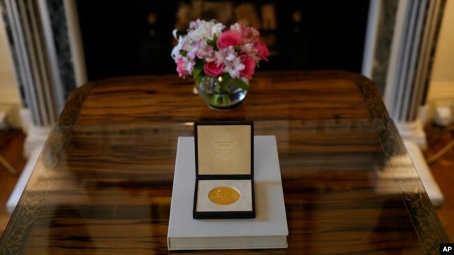 The 2021 Nobel Prize for Literature medal is seen at the Swedish Ambassador's Residence in London, Dec. 6, 2021.