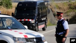 Armed police officers stand guard near Subirats, Spain, Aug. 21, 2017. 