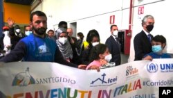 FILE - Some of the 114 refugees evacuated from Libya arrive at Rome's Leonardo Da Vinci International airport in Fiumicino, Italy, November 30, 2022. Originating from Syria and other African countries, they will be hosted in Italy.