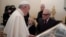 Pope Francis receives a gift from film director Martin Scorsese (right) during a private audience at the Vatican Nov. 30, 2016. 