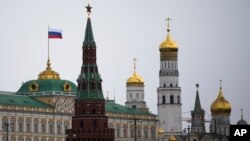 A Russian national flag is seen atop of the Grand Kremlin Palace in Moscow, Russia, March 18, 2014