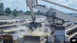 FILE: Grain is offloaded from a ship after it docked in the port of Mombasa, Kenya on Nov. 26, 2022. The vessel arrived with 53,300 tons of wheat procured under the Black Sea Grain Initiative, a deal to ease the export of Ukrainian grain and foodstuffs through the Black Sea,