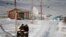 People ride through town on all-terrain vehicles, Jan. 18, 2020, in Toksook Bay, Alaska.