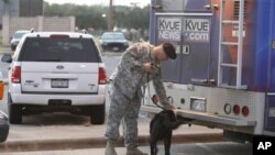 A television news vehicle undergoes a security check outside the U.S. Magistrate court where an Article 32 hearing for Major Nidal Hasan begins 12 Oct 2010 in Fort Hood, Texas