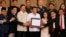 FILE - President Rodrigo Duterte, center, and leaders of the Moro Islamic Liberation Front, including Al Haj Murad Ebrahim, left, Mohagher Iqbal, right, and Ghadzali Jaafar, second from right, hold together the signed "Organic Law for the Bangsamoro Autonomous Region in Muslim Mindanao" during a presentation at Malacanang Palace in Manila, Philippines, Aug. 6, 2018.
