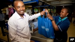 A customer carries his shopping in a cloth carrier bag in Nairobi, Kenya, Aug. 28, 2017. 