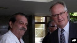 European Commission Director for the Americas and chief negotiator Christian Leffler, right, greets Cuba's Deputy Minister Abelardo Moreno before the start of their meeting in Havana, Cuba, March 4, 2015.
