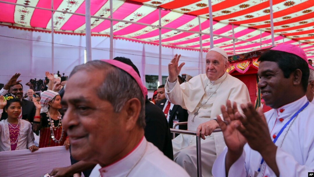 Pope Francis arrives on a cycle rickshaw at an event to meet representatives of different religions in Dhaka, Bangladesh, Friday, Dec. 1, 2017.