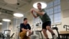 Physical therapist Tyler Detmer, left, works with patient Jacob Bullard at WashU, Monday, Dec. 16, 2024, in St. Louis. (AP Photo/Jeff Roberson)