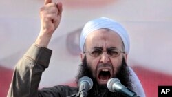 FILE - In this March 4, 2011, file photo, Sheikh Ahmed al-Assir, a Lebanese anti-Syrian regime leader, addresses his supporters during a demonstration against Syrian President Bashar Assad.