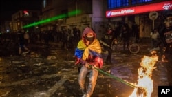 Demonstrators clash with police during protests sparked by the death of a man after he was detained by police in Bogota, Sept. 9, 2020. 