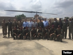 FILE - Members of a U.S. congressional delegation, headed by Republican Senator John McCain, pose for a picture with Dragon helicopter pilots from the Pakistani Air Force in Miramshah, North Waziristan, Pakistan, July 3, 2016. (@SenJohnMcCain)