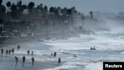 FILE - People cool off at the beach during a Southern California heat wave in Oceanside, California, Oct. 24, 2017. 