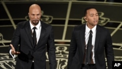 Common, left, and John Legend perform at the 87th Annual Academy Awards, Los Angeles, Feb. 22, 2015.