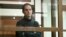 FILE - Wall Street Journal reporter Evan Gershkovich stands in a glass cage in a courtroom at the Moscow City Court in Moscow, Russia, on Dec. 14, 2023.