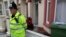 FILE - A police officer stands outside a house after police arrested three men and three women in a counter-terrorism operation linked to the civil war in Syria, in Portsmouth, southern England, Oct. 14, 2014. 